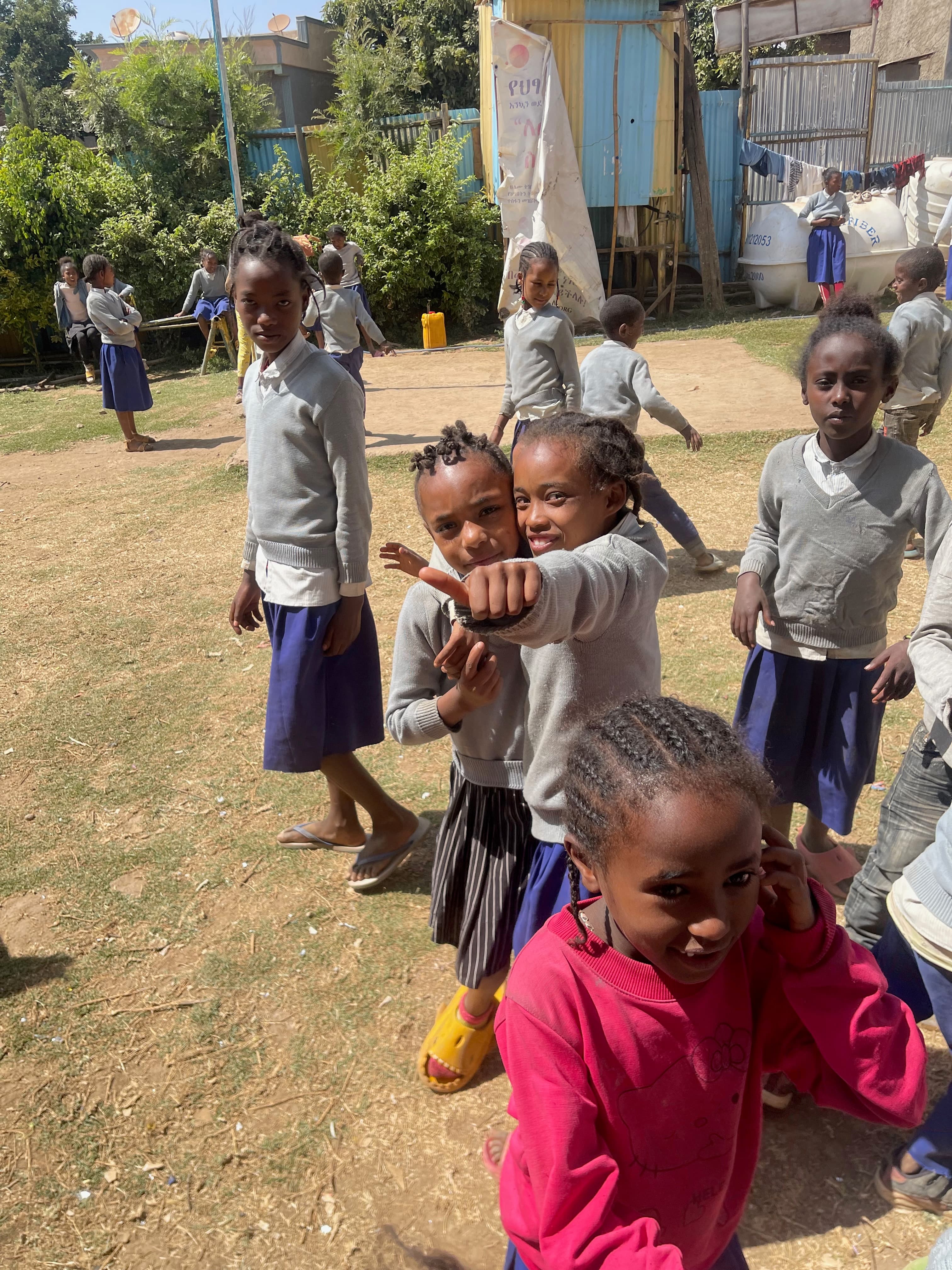 Children playing and smiling at the BTO school grounds today